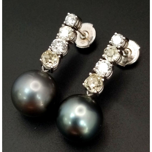 883 - A Pair of 18K White Gold, Diamond and Large Grey Pearl Drop Earrings. 1.6ctw of brilliant round cut ... 