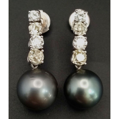 883 - A Pair of 18K White Gold, Diamond and Large Grey Pearl Drop Earrings. 1.6ctw of brilliant round cut ... 