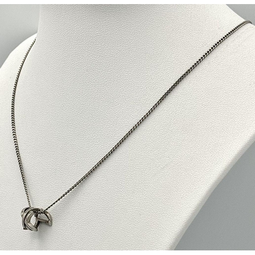 988 - A Designer Yves St. Laurent Pendant and Chain. White metal. 
10mm and 42cm. Ref: 18915