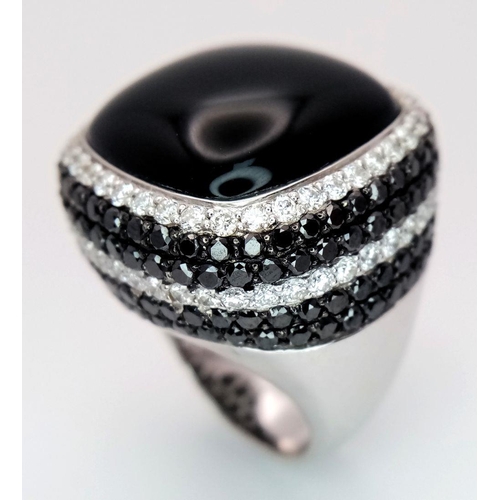 547 - An 18K White Gold, Diamond and Onyx Dress Ring. Make a statement with this rich square of black onyx... 