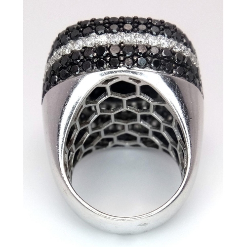 547 - An 18K White Gold, Diamond and Onyx Dress Ring. Make a statement with this rich square of black onyx... 