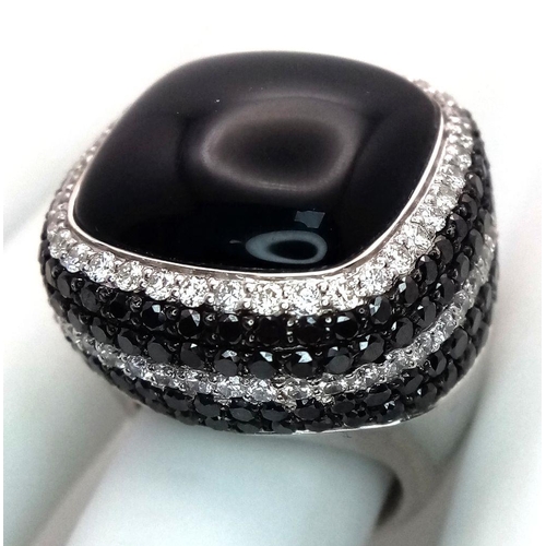 547 - An 18K White Gold, Diamond and Onyx Dress Ring. Make a statement with this rich square of black onyx... 