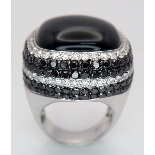 547 - An 18K White Gold, Diamond and Onyx Dress Ring. Make a statement with this rich square of black onyx... 