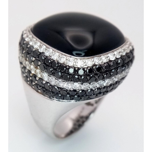 547 - An 18K White Gold, Diamond and Onyx Dress Ring. Make a statement with this rich square of black onyx... 