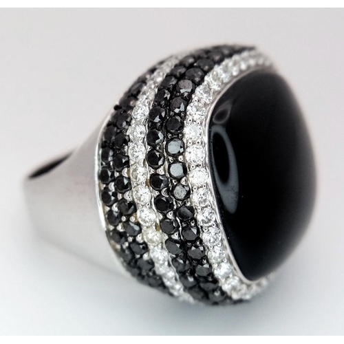 547 - An 18K White Gold, Diamond and Onyx Dress Ring. Make a statement with this rich square of black onyx... 