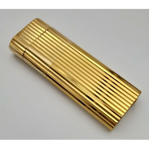 813 - A Vintage Cartier Gold Plated Lighter. Geometric ridged pattern. In need of gas and flint. UK mainla... 