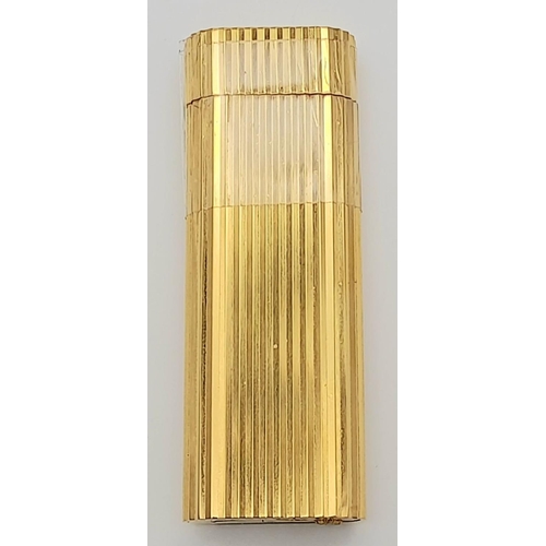 813 - A Vintage Cartier Gold Plated Lighter. Geometric ridged pattern. In need of gas and flint. UK mainla... 