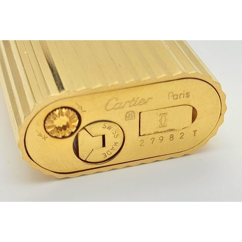 813 - A Vintage Cartier Gold Plated Lighter. Geometric ridged pattern. In need of gas and flint. UK mainla... 