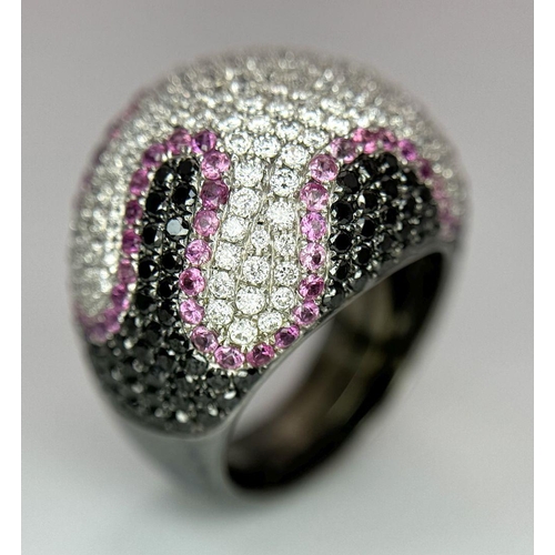 554 - An Elaborate 18K White Gold Multi-Coloured Diamond Dress Ring. Abstract pave design, with white, bla... 