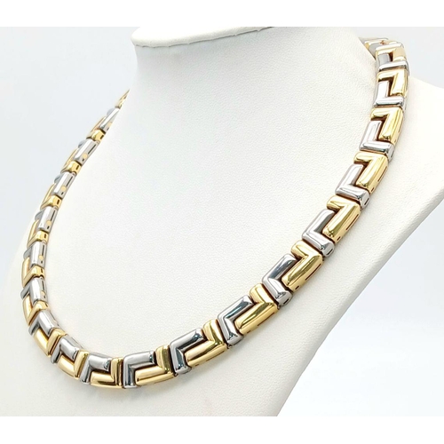 561 - A Gorgeous Bvlgari Collar Necklace in 18K Gold and Steel. Geometric design. Hinged clip mechanism. I... 