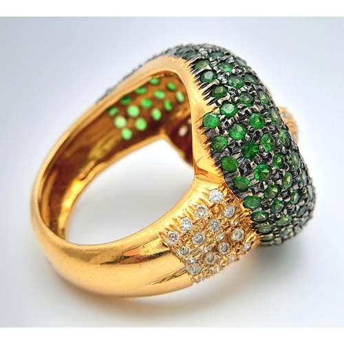 659 - An 18K Yellow Gold, Diamond and Emerald Abstract Ring. Serpent-esque in nature this pave diamond and... 