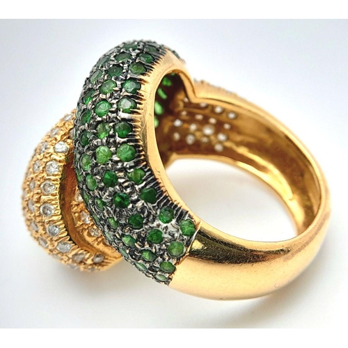 659 - An 18K Yellow Gold, Diamond and Emerald Abstract Ring. Serpent-esque in nature this pave diamond and... 