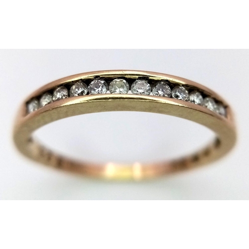 1099 - A 9K YELLOW GOLD AND DIAMOND HALF ETERNITY RING. 0.25CTW. 2.1G. SIZE T. A/S SC5.