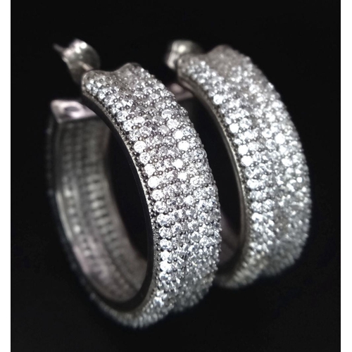 1267 - A PAIR OF STERLING SILVER FANCY STONE SET HOOP EARRINGS (three stones missing). 14.5G. SC 3084.