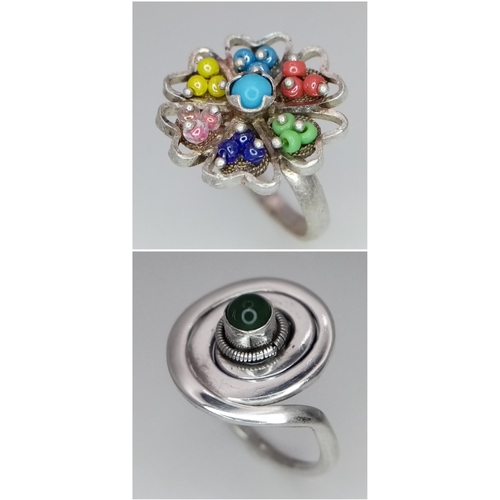 1288 - 2 X STERLING SILVER STONE SET FANCY RINGS. SWIRL DESIGN & FLOWER. 8.7G TOTAL WEIGHT. BOTH SIZE N.

r... 