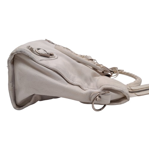 603 - A Balenciaga cream city leather handbag, silver tone hardware, black cloth interior with zip pocket,... 