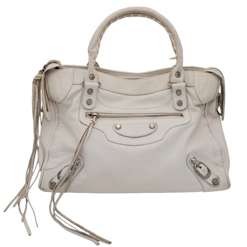 603 - A Balenciaga cream city leather handbag, silver tone hardware, black cloth interior with zip pocket,... 