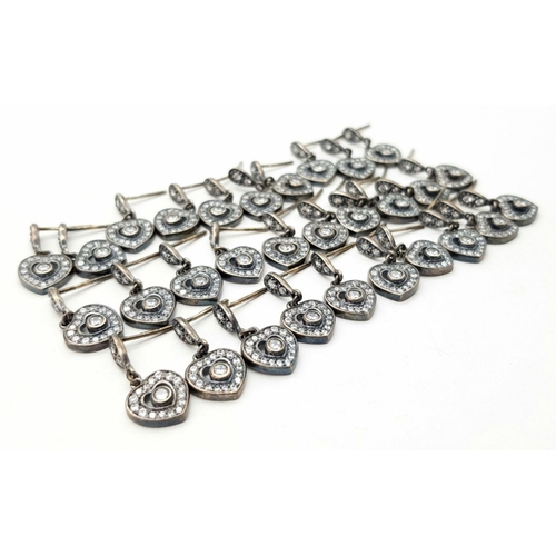 1393 - Lot of 14 Pairs of Sterling Silver and White Stone Heart Earrings. No backs. 35g total weight.