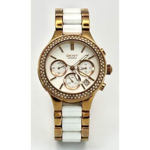 1164 - A rose gold plated, Ceramic DKNY Chronometer watch, 38 mm case, bezel with cubic zirconia, white dia... 