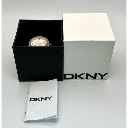 1164 - A rose gold plated, Ceramic DKNY Chronometer watch, 38 mm case, bezel with cubic zirconia, white dia... 