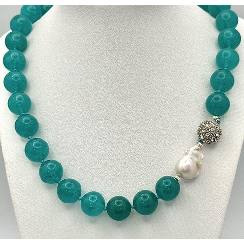 1410 - A Large Blue Topaz Beaded Necklace with Baroque Pearl Interrupter. 14mm beads. 44cm necklace length.... 