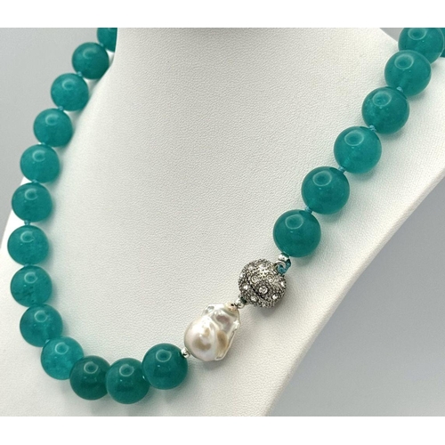 1410 - A Large Blue Topaz Beaded Necklace with Baroque Pearl Interrupter. 14mm beads. 44cm necklace length.... 