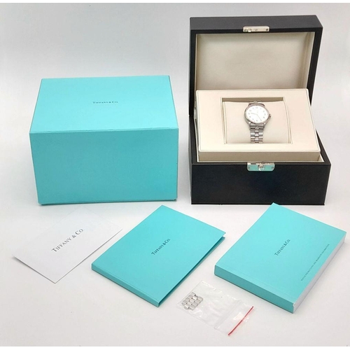 631 - A Tiffany and Co. Automatic Ladies Watch. Stainless steel bracelet and case - 34mm. White dial. Skel... 