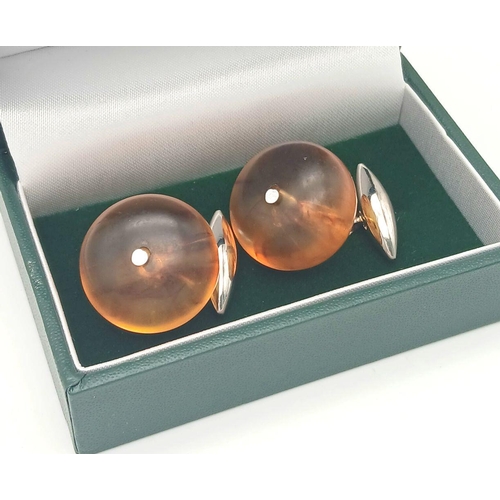 1416 - A pair of amber resin cufflinks. Comes with box. 13g in weight.