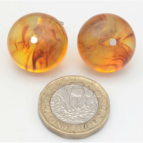 1416 - A pair of amber resin cufflinks. Comes with box. 13g in weight.