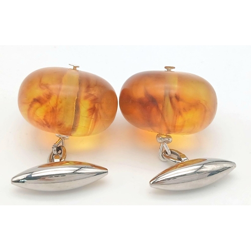 1416 - A pair of amber resin cufflinks. Comes with box. 13g in weight.