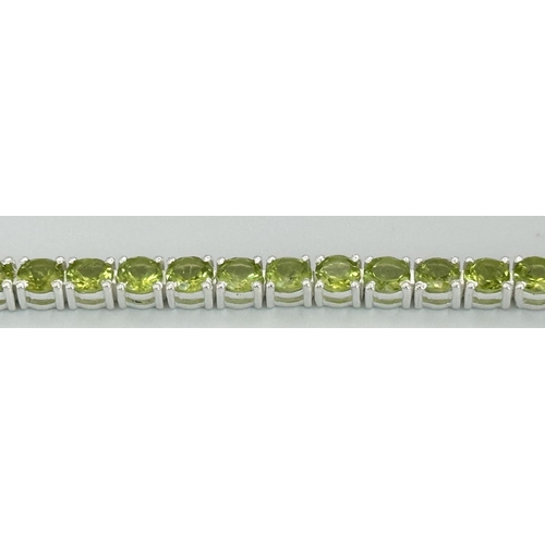 1290 - A Peridot Gemstone Tennis Bracelet set in 925 Silver. 17cm length. CD-1498