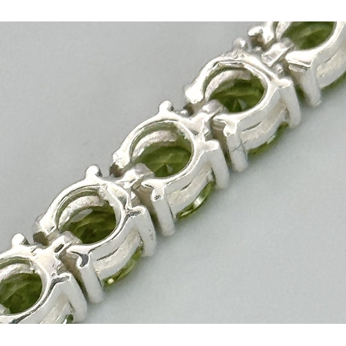 1290 - A Peridot Gemstone Tennis Bracelet set in 925 Silver. 17cm length. CD-1498