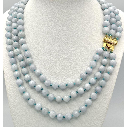 1558 - A Three Row Turquoise Beaded Necklace. 8mm beads. Gilded clasp.  40-46cm length.