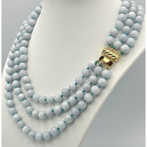 1558 - A Three Row Turquoise Beaded Necklace. 8mm beads. Gilded clasp.  40-46cm length.