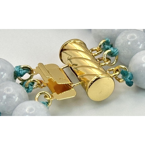 1558 - A Three Row Turquoise Beaded Necklace. 8mm beads. Gilded clasp.  40-46cm length.