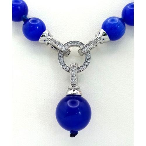 1450 - A Blue Cats Eye Necklace with Hanging Pendant. 42cm necklace length.