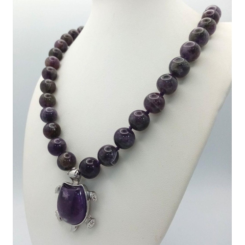 471 - An Amethyst Bead Necklace with Hanging Amethyst Turtle Pendant. Pendant - 4cm. Necklace 44cm.