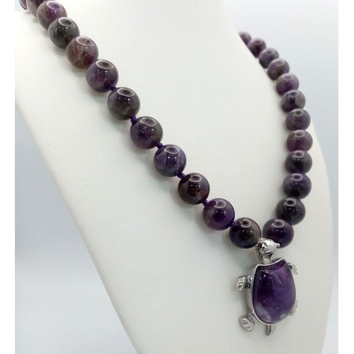 471 - An Amethyst Bead Necklace with Hanging Amethyst Turtle Pendant. Pendant - 4cm. Necklace 44cm.