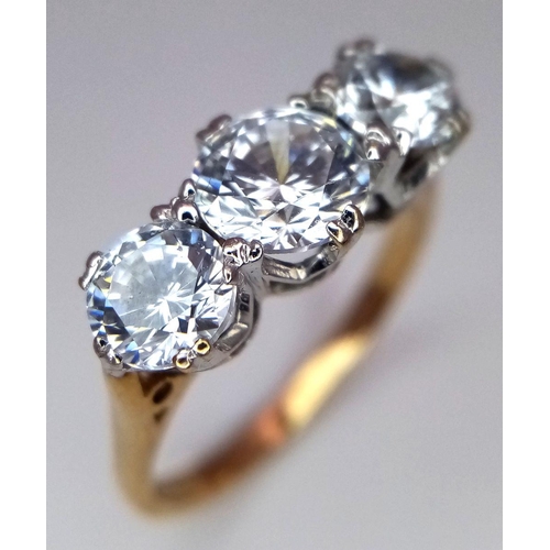 674 - A 9K Yellow Gold Three Stone Zircon Ring. Size K. 2.5g total weight. Comes with a case.