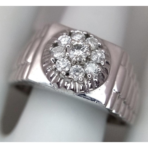 205 - A Gents 9K White Gold Diamond Ring. 0.5ctw of brilliant round cut diamonds with decorative geometric... 