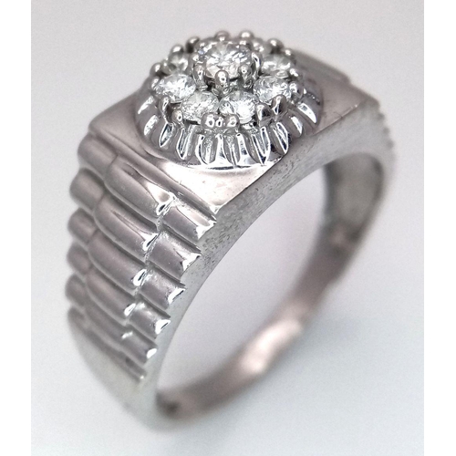 205 - A Gents 9K White Gold Diamond Ring. 0.5ctw of brilliant round cut diamonds with decorative geometric... 