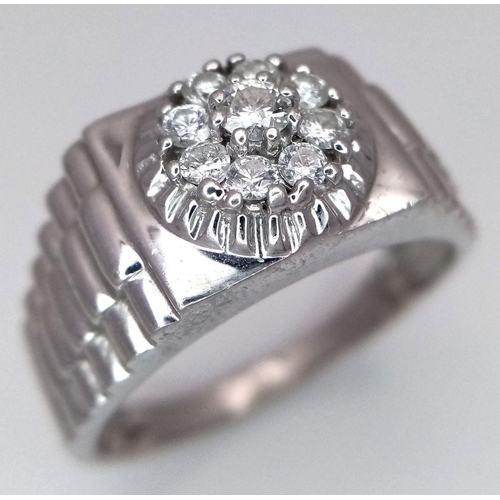 205 - A Gents 9K White Gold Diamond Ring. 0.5ctw of brilliant round cut diamonds with decorative geometric... 