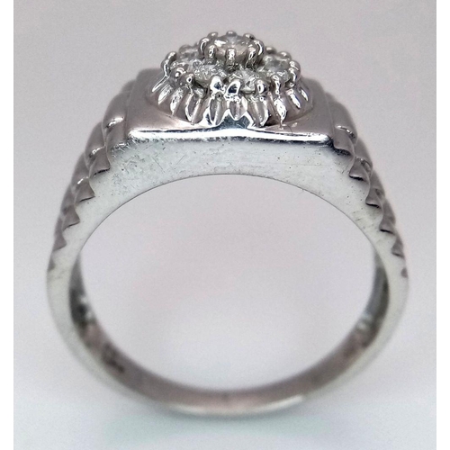 205 - A Gents 9K White Gold Diamond Ring. 0.5ctw of brilliant round cut diamonds with decorative geometric... 