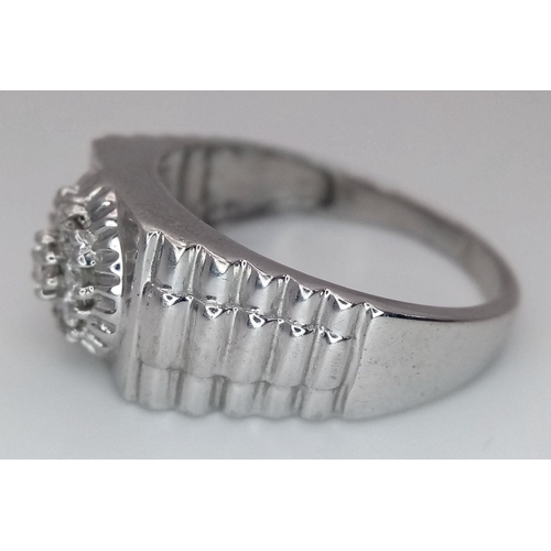 205 - A Gents 9K White Gold Diamond Ring. 0.5ctw of brilliant round cut diamonds with decorative geometric... 