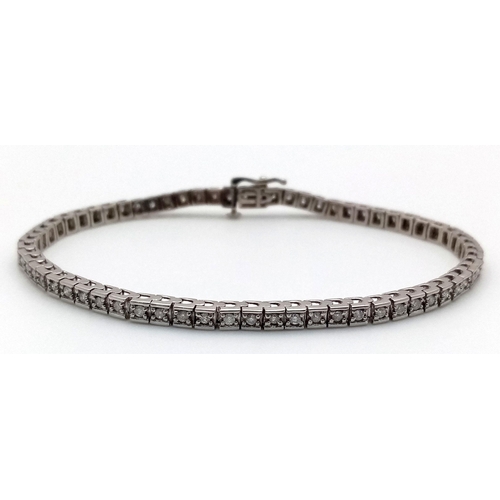 212 - A 10K White Gold Diamond Tennis Bracelet. 65 small round cut diamonds. 19cm length. 10.25g total wei... 