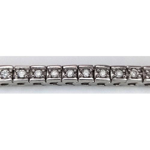 212 - A 10K White Gold Diamond Tennis Bracelet. 65 small round cut diamonds. 19cm length. 10.25g total wei... 