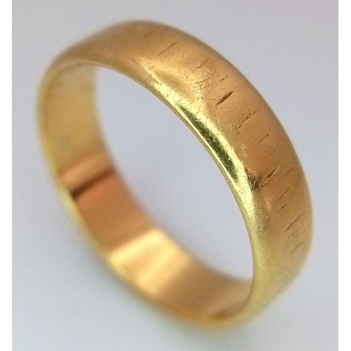 31 - An 18K Yellow Gold Band Ring. Full UK hallmarks. 5mm width. Size L1/2. 3.7g.