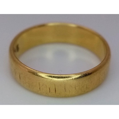 31 - An 18K Yellow Gold Band Ring. Full UK hallmarks. 5mm width. Size L1/2. 3.7g.