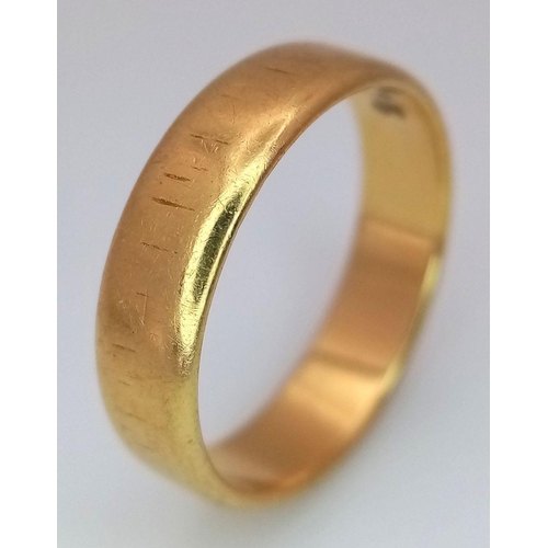 31 - An 18K Yellow Gold Band Ring. Full UK hallmarks. 5mm width. Size L1/2. 3.7g.