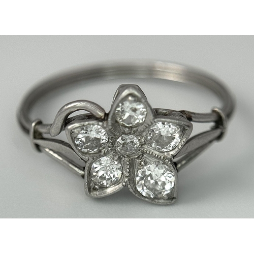 403 - A Platinum (tested as) Diamond Flower Ring, 0.39ct diamond weight, 2.48g total weight, size N 1/2. 
... 